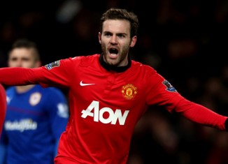 Juan Mata of Manchester United celebrates Robin van Persie scoring their first goal during the Barcl